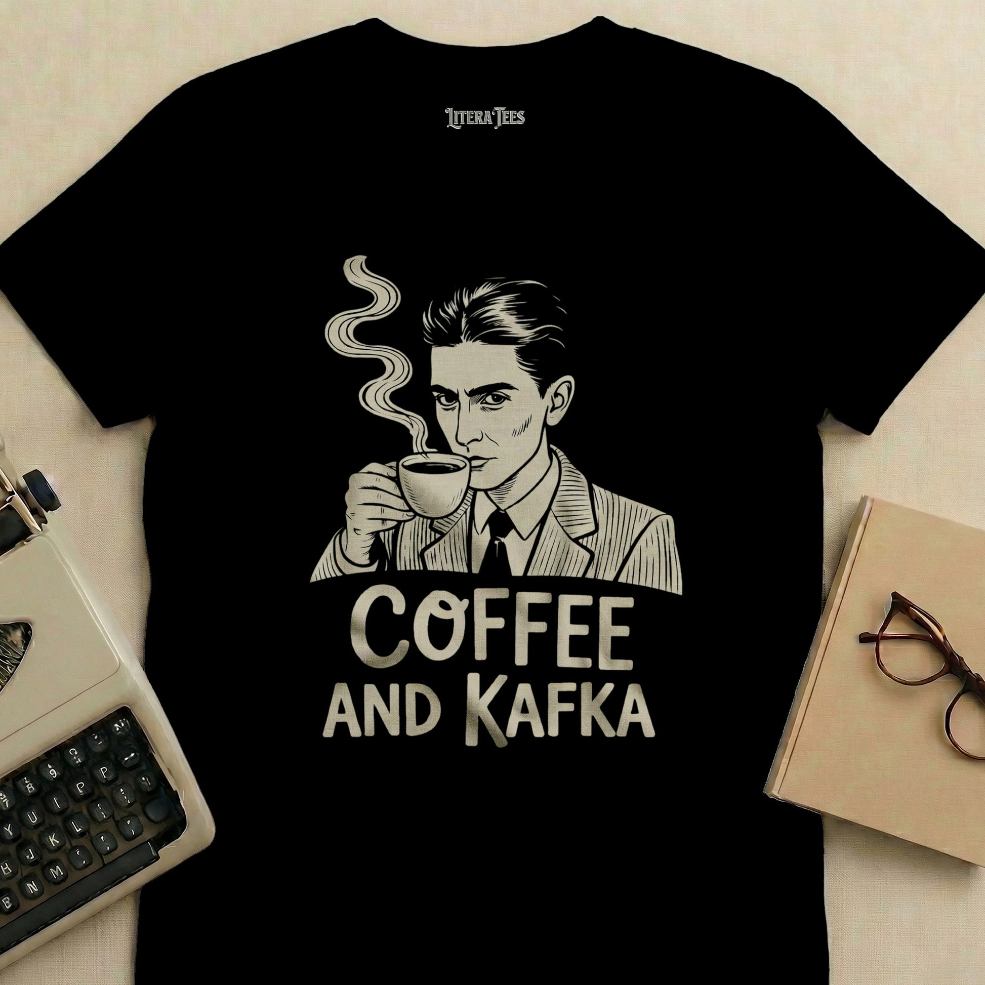 Black t-shirt with "Coffee and Kafka" text and a line-art illustration of a man drinking coffee.