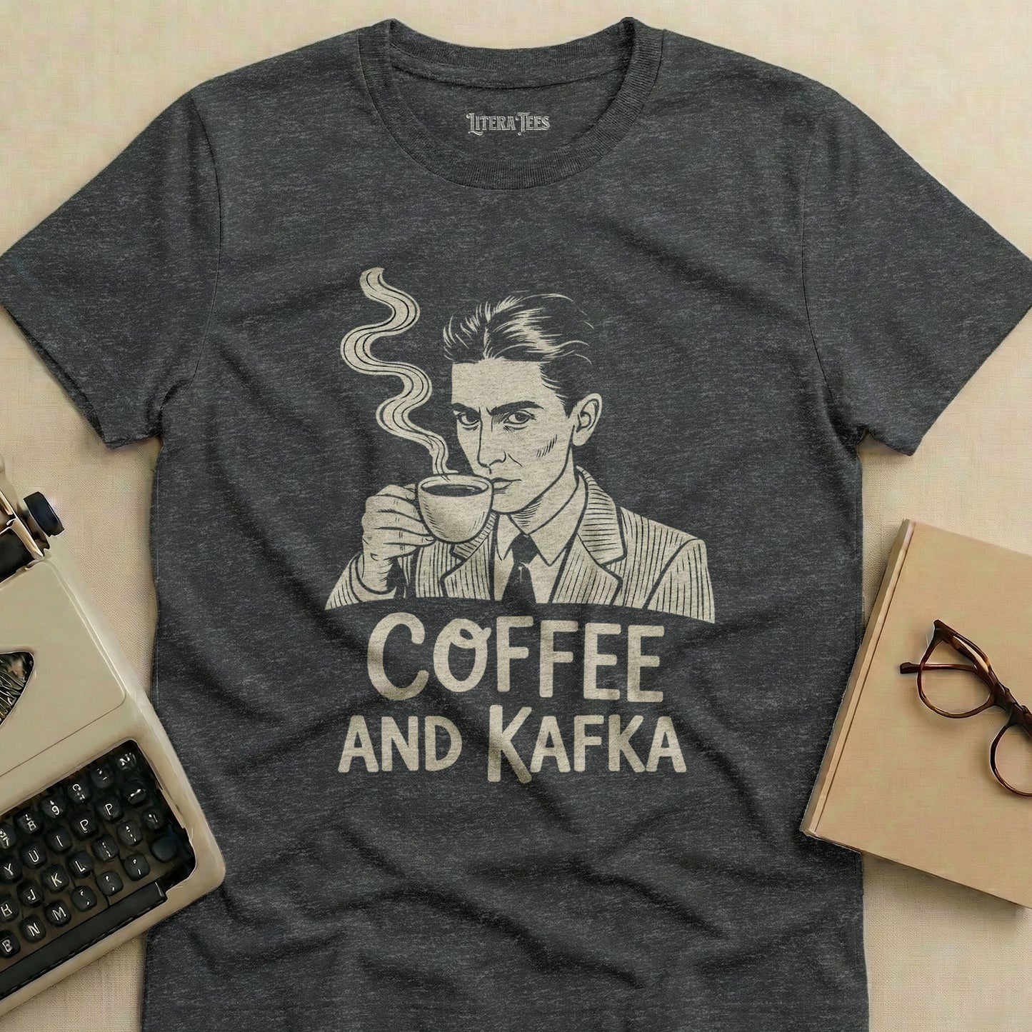 Dark gray t-shirt with a man drinking coffee and "COFFEE AND KAFKA" text.