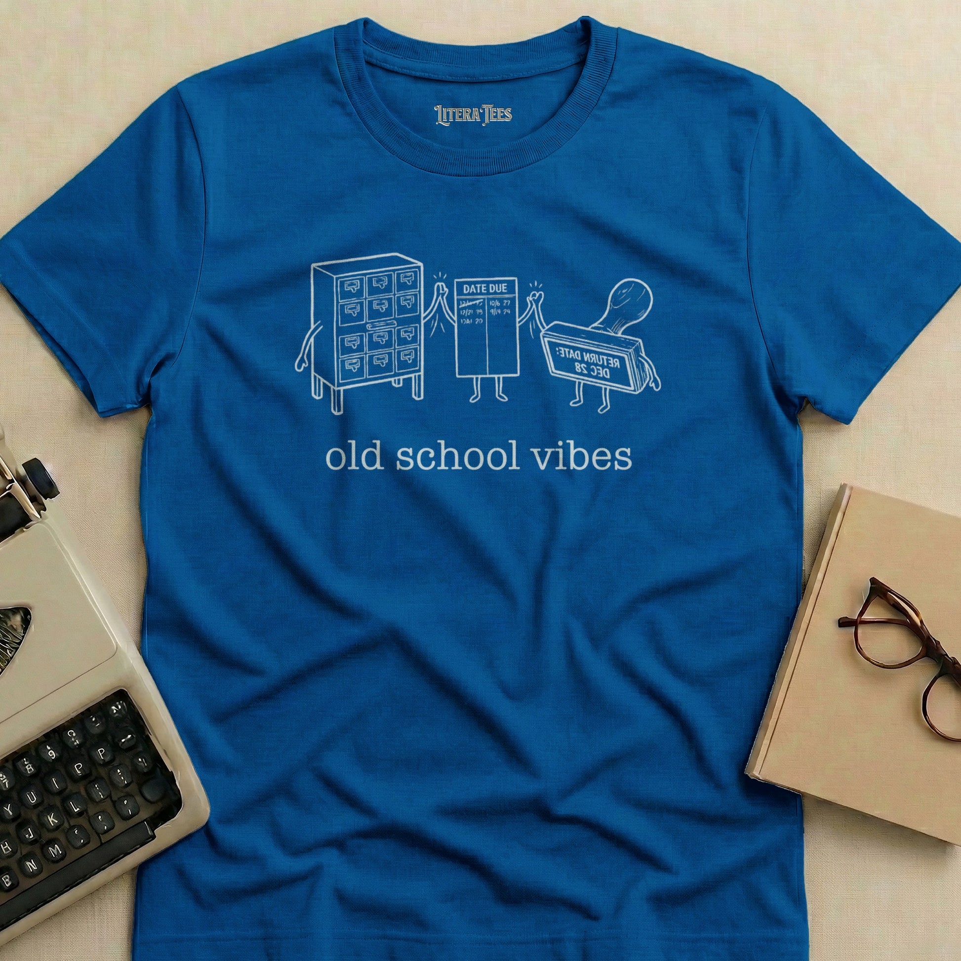 Blue t-shirt with "old school vibes" and library card graphics.