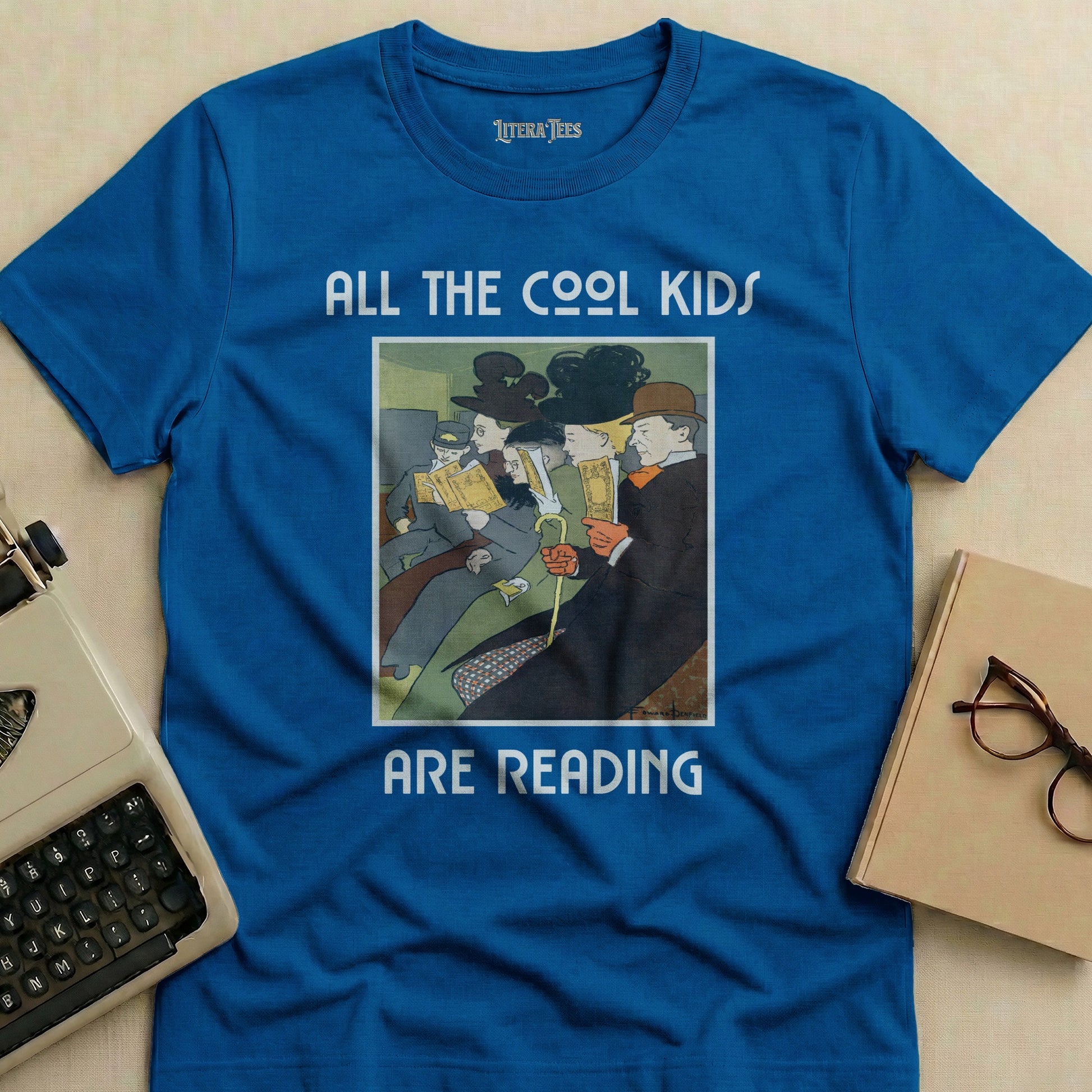 Blue t-shirt with text "ALL THE COOL KIDS ARE READING" and vintage illustration.