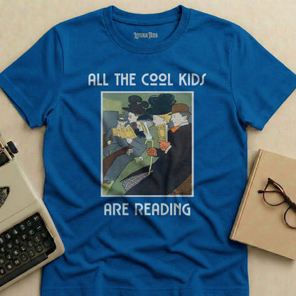 Blue t-shirt with text "ALL THE COOL KIDS ARE READING" and vintage illustration.