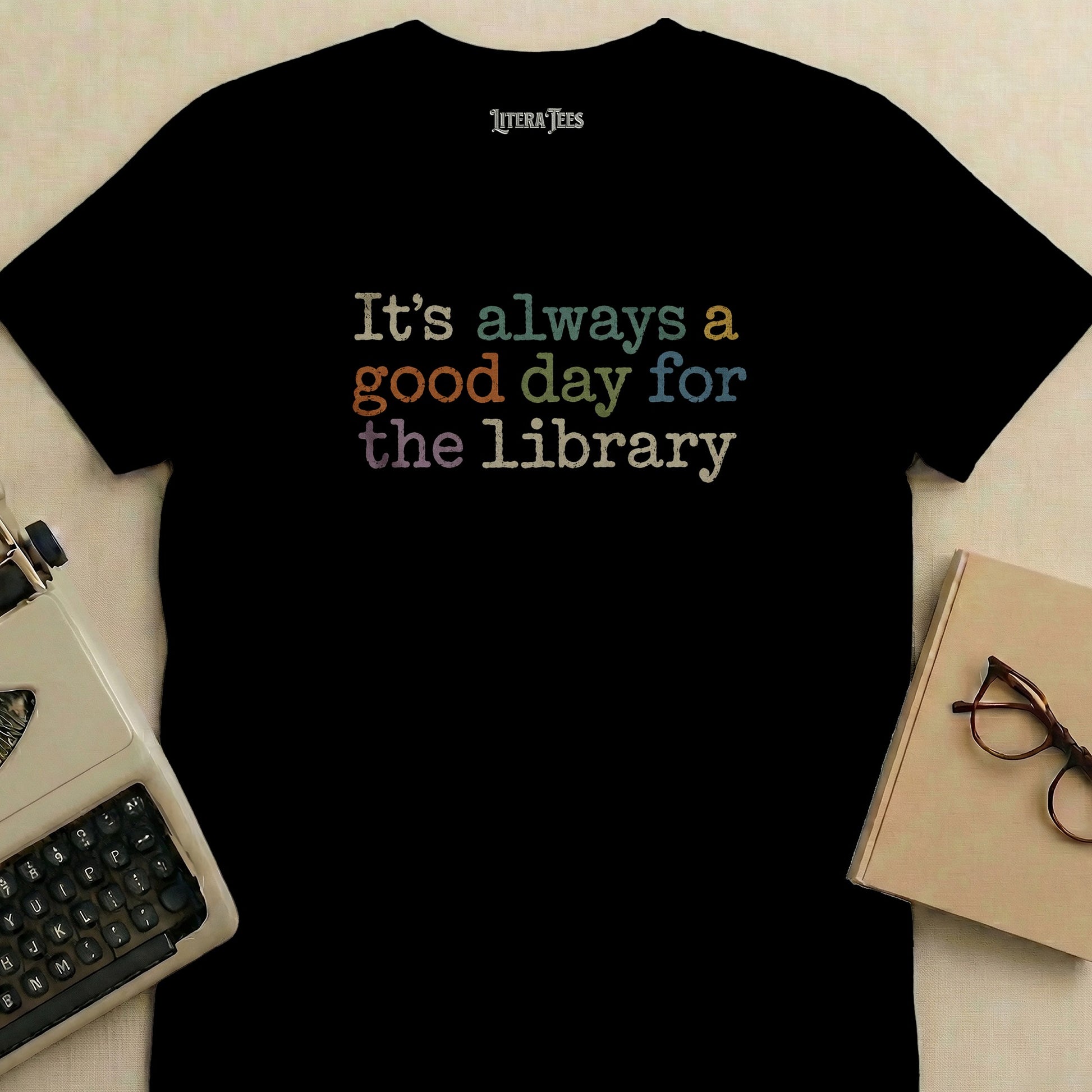 Black t-shirt with "It's always a good day for the library" text.