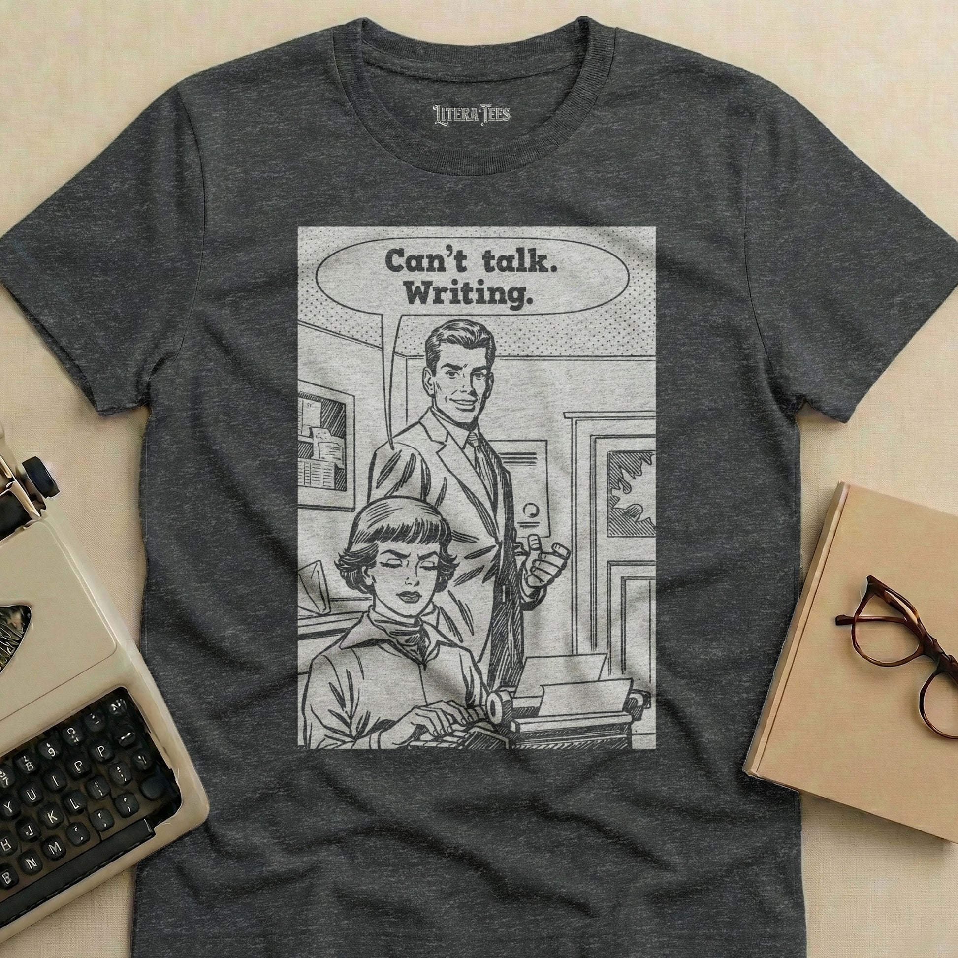 T-shirt with comic panel of couple and typewriter, text "Can't talk. Writing."