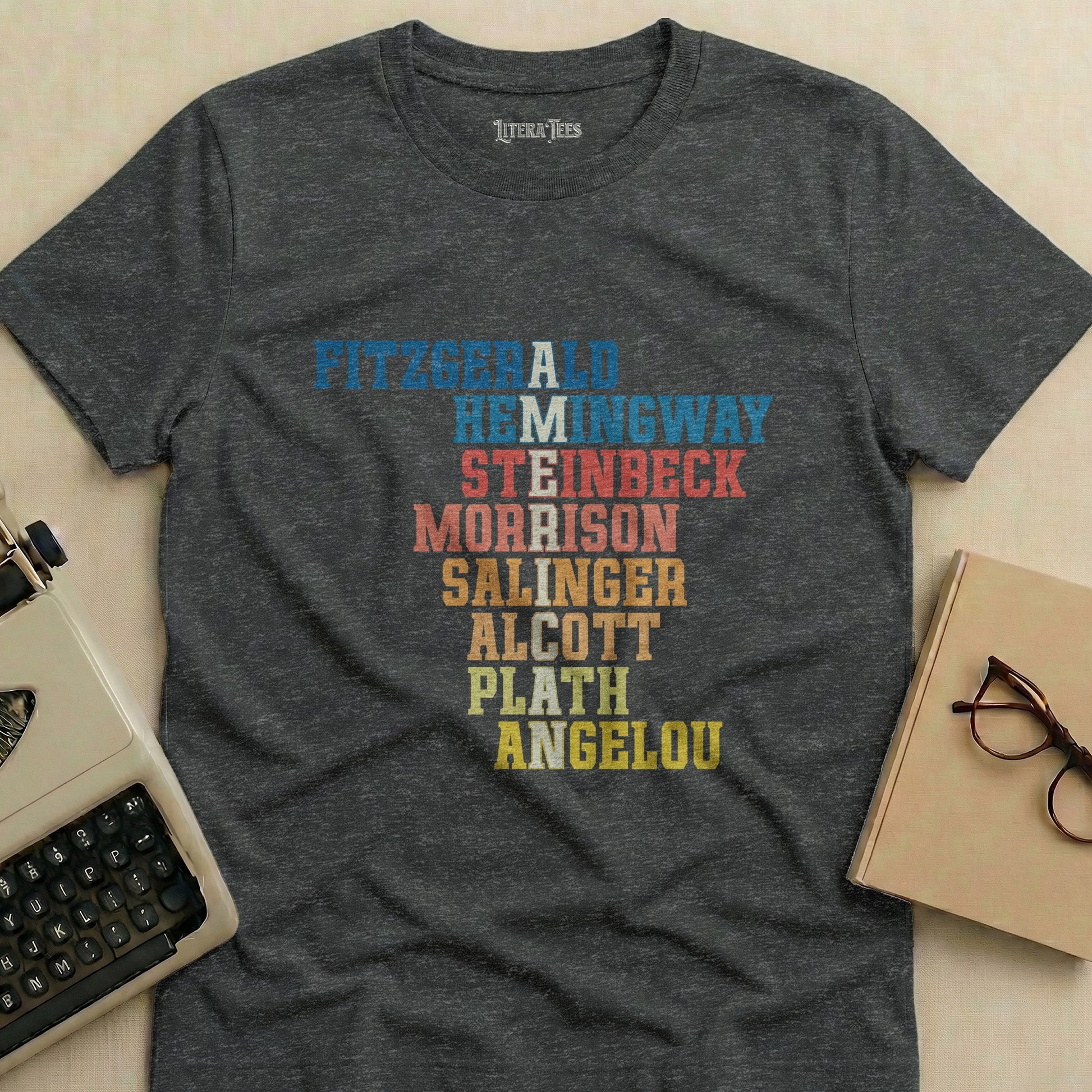 Dark t-shirt with names of authors in colorful distressed lettering.