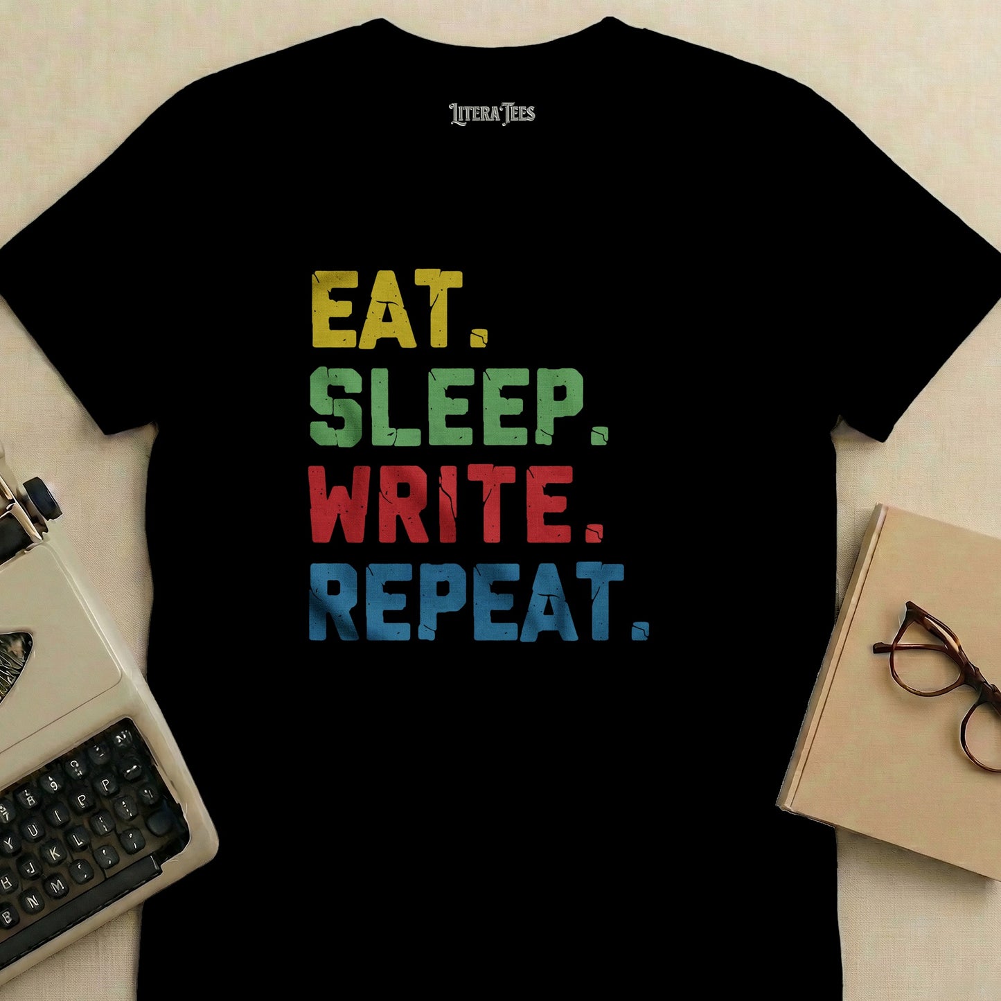 Black t-shirt with "EAT. SLEEP. WRITE. REPEAT." in colorful block letters.