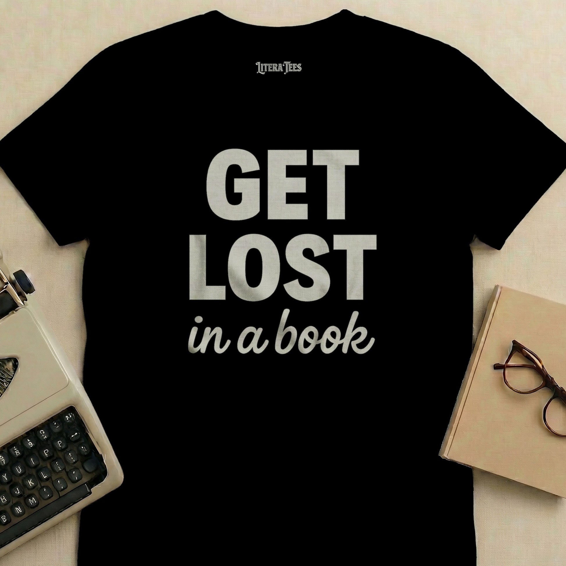 Black t-shirt with white text "GET LOST in a book" from LITERA TEES.