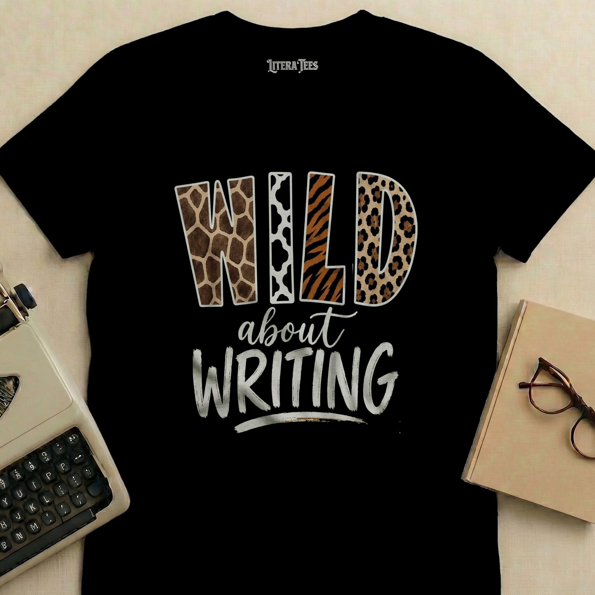 Black t-shirt with "WILD about WRITING" text in animal print.