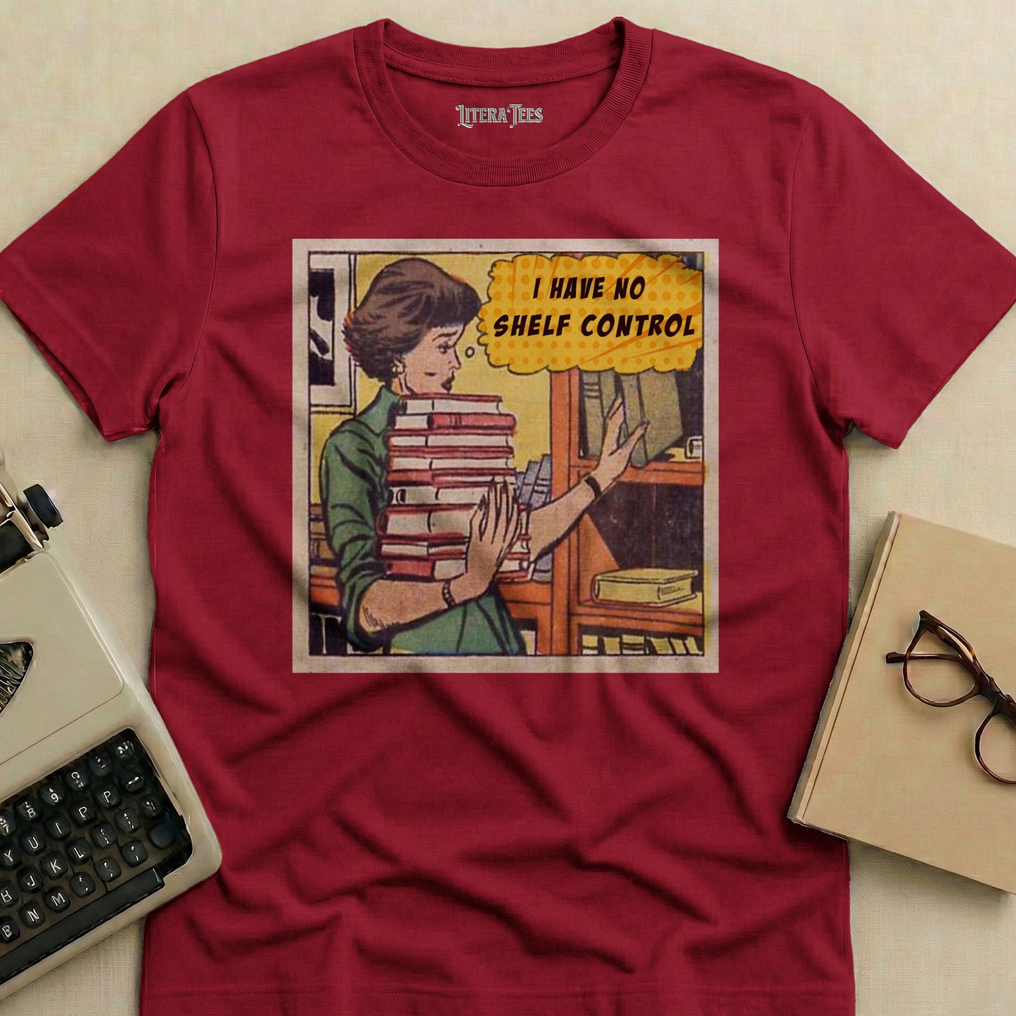 Maroon t-shirt with a comic-style graphic and "I HAVE NO SHELF CONTROL" text.