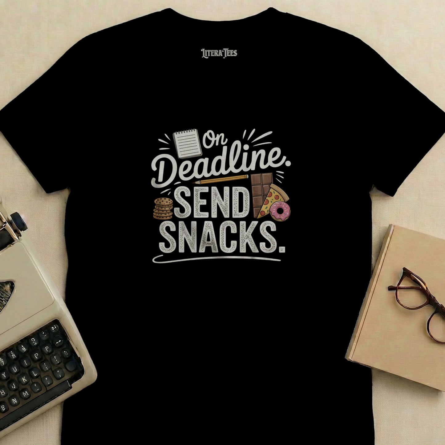 T-shirt with "On Deadline. SEND SNACKS." text and snack illustrations.